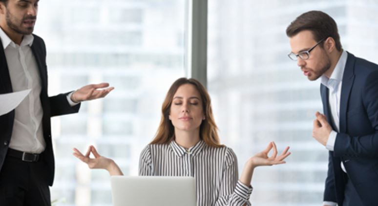 Office tension with meditating employee