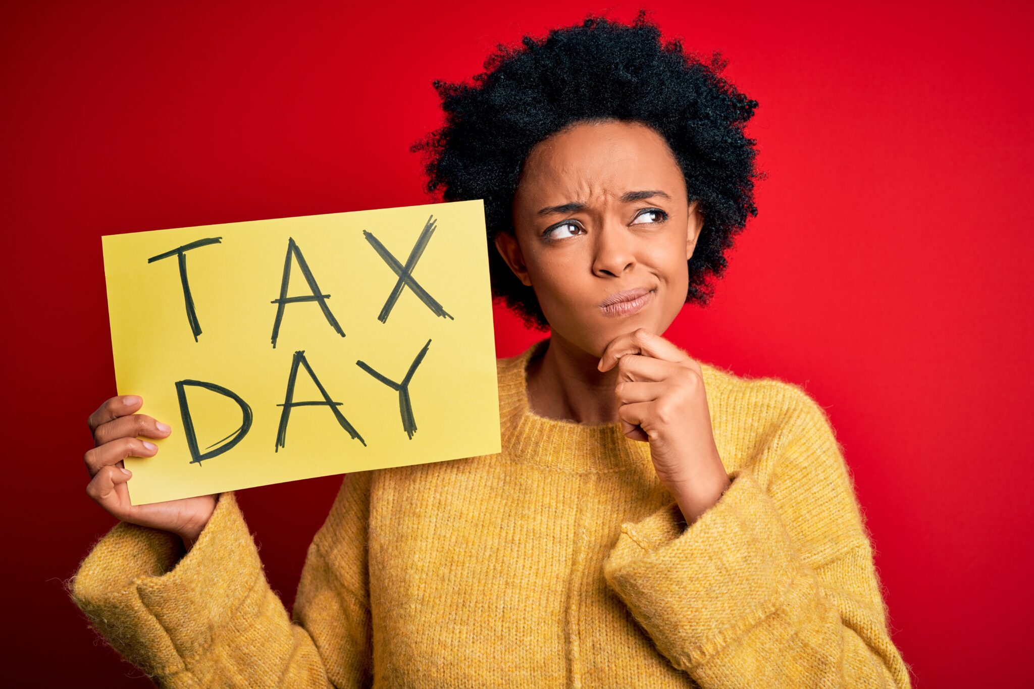 Person holding tax day sign