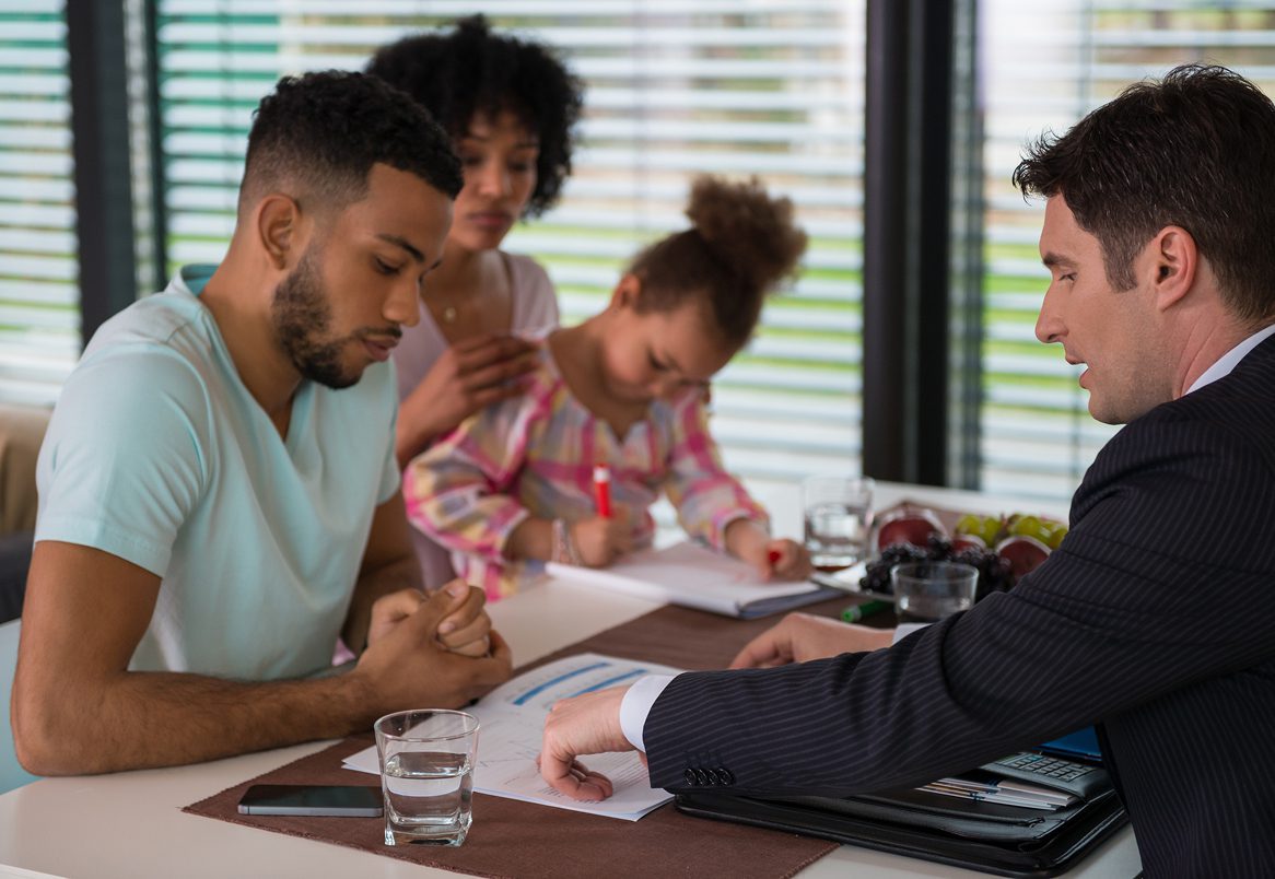Parents and child discussing documents