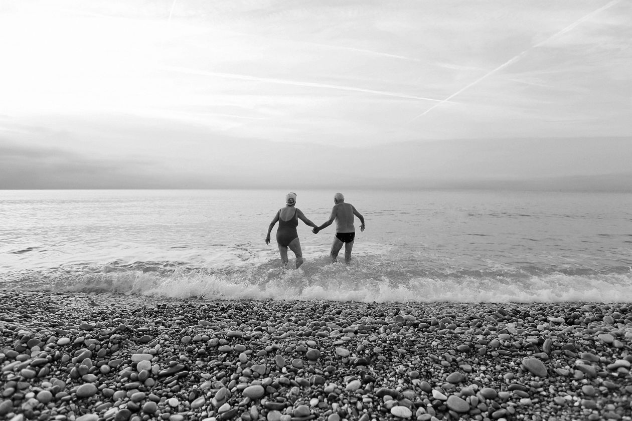 Seniors walking into the sea
