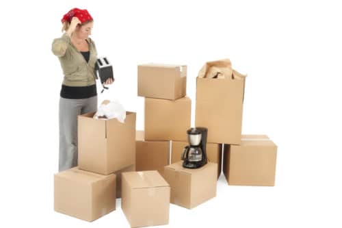 Woman packing boxes with household items