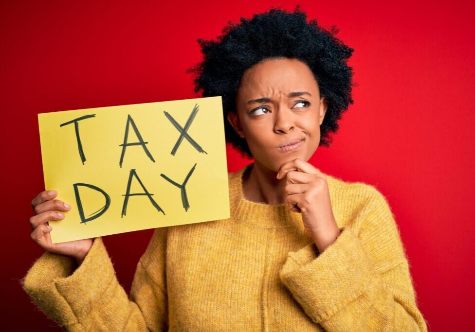 Person holding tax day sign